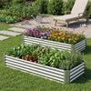 Galvanized raised garden bed with flowers and vegetables, featuring sturdy corrugated panels for outdoor planting.