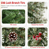 Close-up of flocked pine needles and PVC leaves on a 6 ft artificial Christmas tree, featuring natural pine cones and.