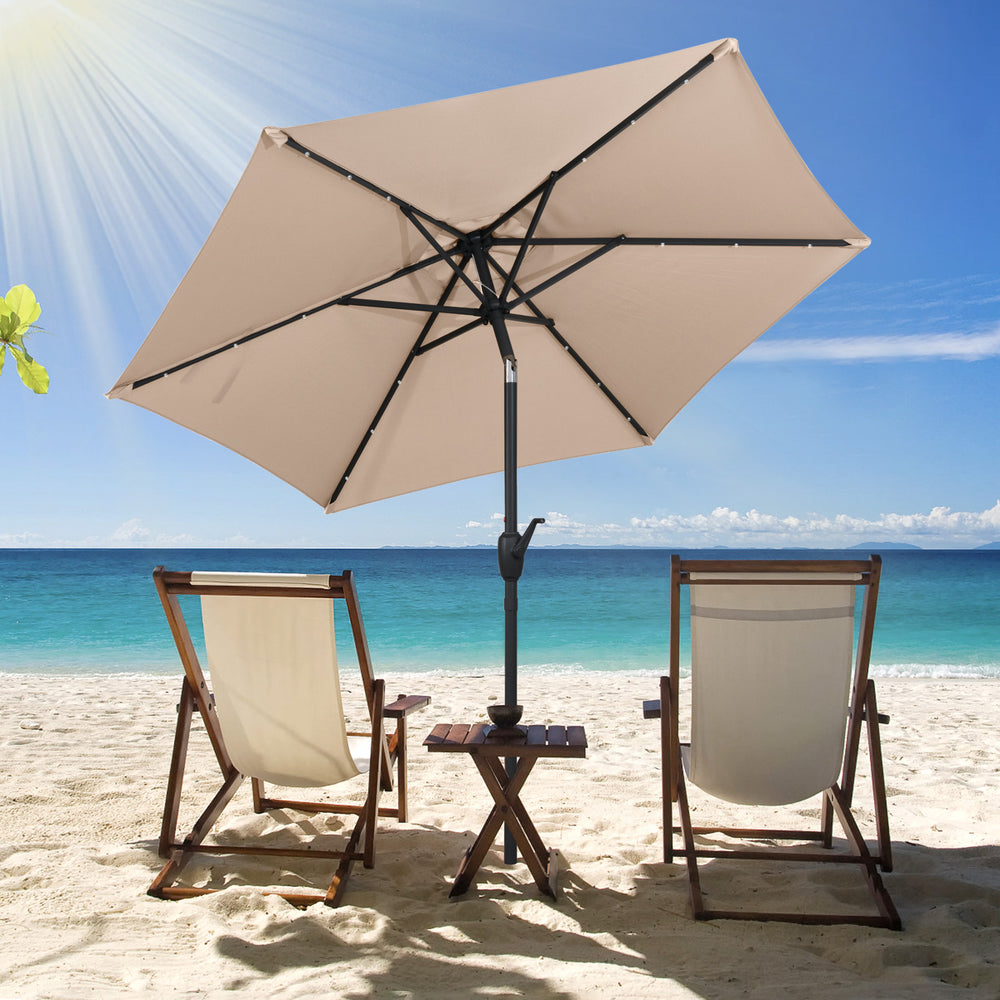 Tan 7.5 feet solar-powered patio umbrella with LED lights, crank handle, and push button tilt for optimal shade on the.