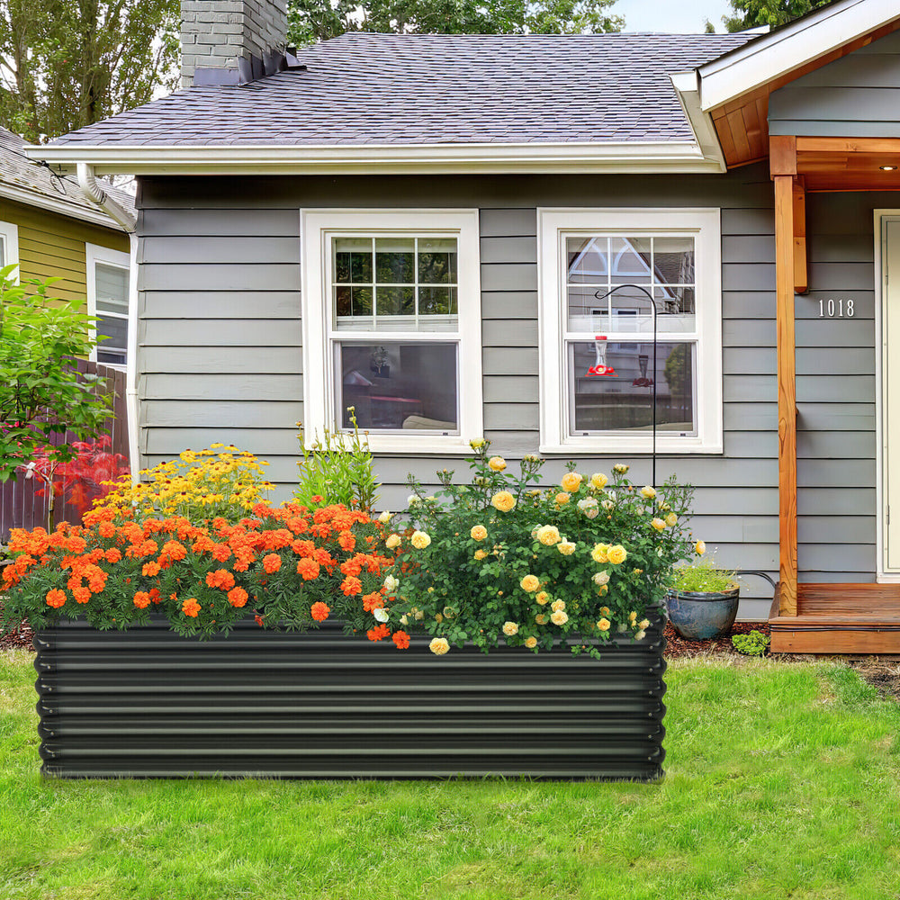 Galvanized metal raised garden bed in dark gray, featuring vibrant flowers, perfect for backyard gardening.