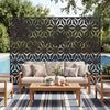 Freestanding black fence panel with hollow-carved design, enhancing privacy for patio or poolside use.
