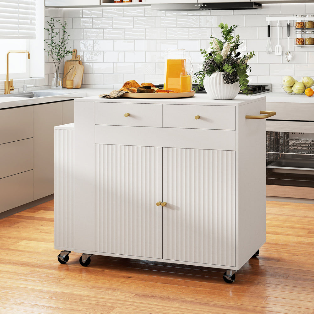 Kitchen island with extendable dining table, storage drawers, and spice racks, featuring fluted doors and wheels for mobility.