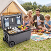 Portable 74 quart rolling cooler in gray with wheels, holding drinks and fruits, ideal for camping and outdoor activities.