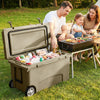 75 quart portable hard cooler in khaki with wheels, ideal for camping and picnics, shown with food and drinks inside.