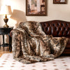 Luxurious 760GSM faux raccoon fur blanket draped over a sofa, featuring a soft texture for cozy warmth and style.