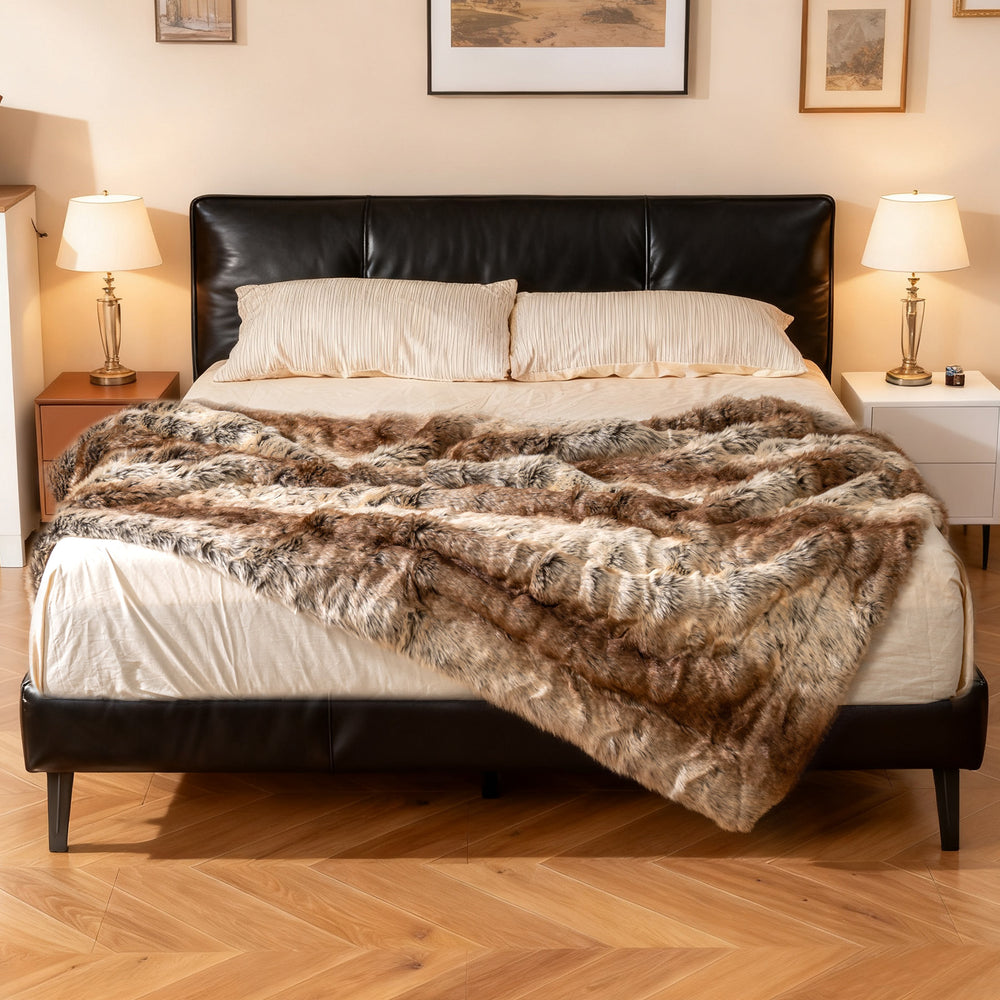 Soft plush fuzzy luxury faux raccoon fur blanket on a bed, featuring a double-sided design for warmth and comfort.