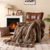 Luxury faux fox fur blanket in brown draped over a chair, featuring a soft texture and double-sided design for comfort.