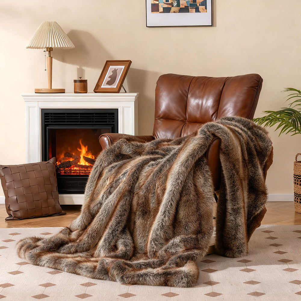 Luxury faux fox fur blanket in brown draped over a chair, featuring a soft texture and double-sided design for comfort.