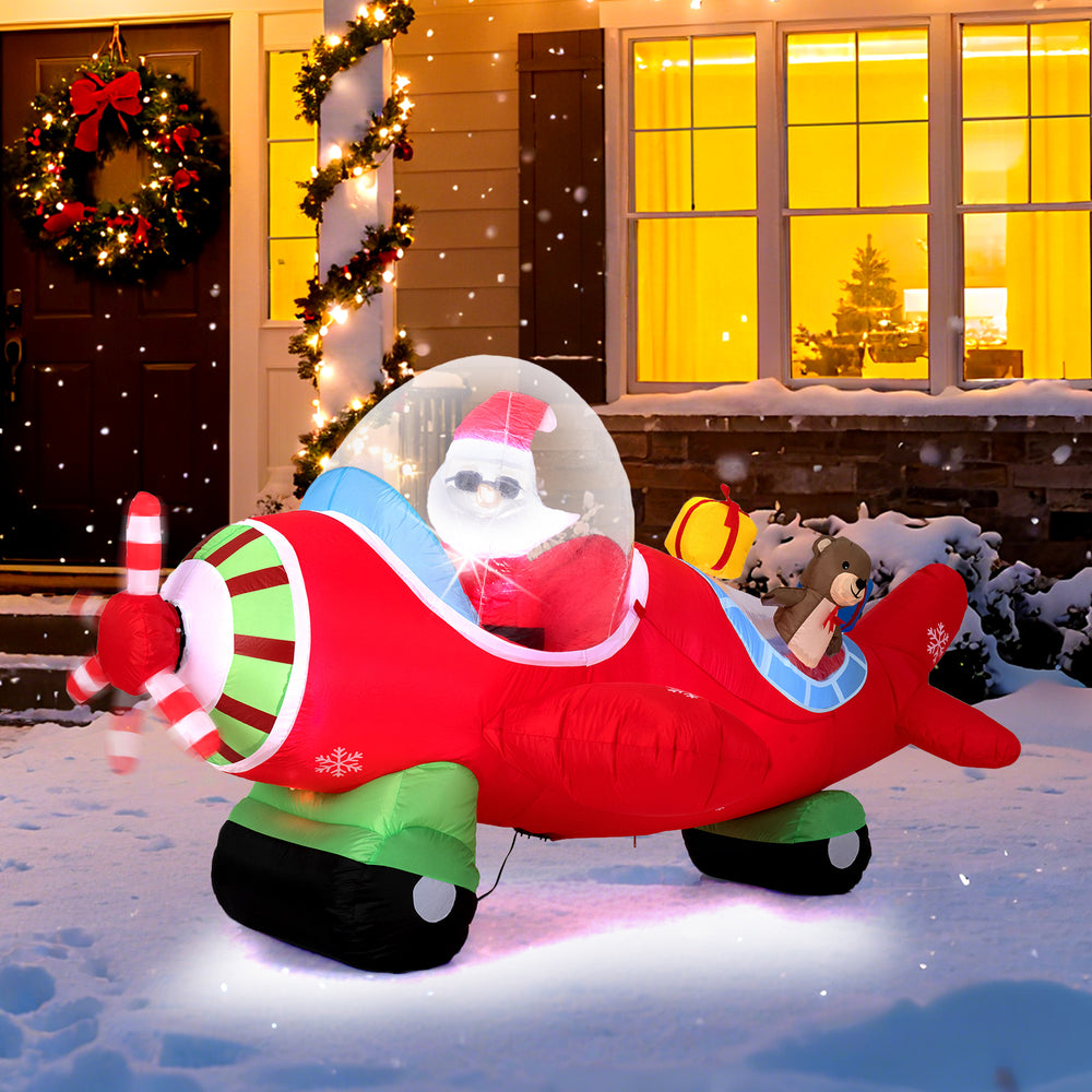Santa Claus in a 7.2 feet inflatable airplane with LED lights and gift boxes, perfect for outdoor Christmas displays.