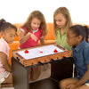 Children playing with the 2-in-1 Indoor/Outdoor Air Hockey Foosball Game Table, featuring rotating surfaces for.