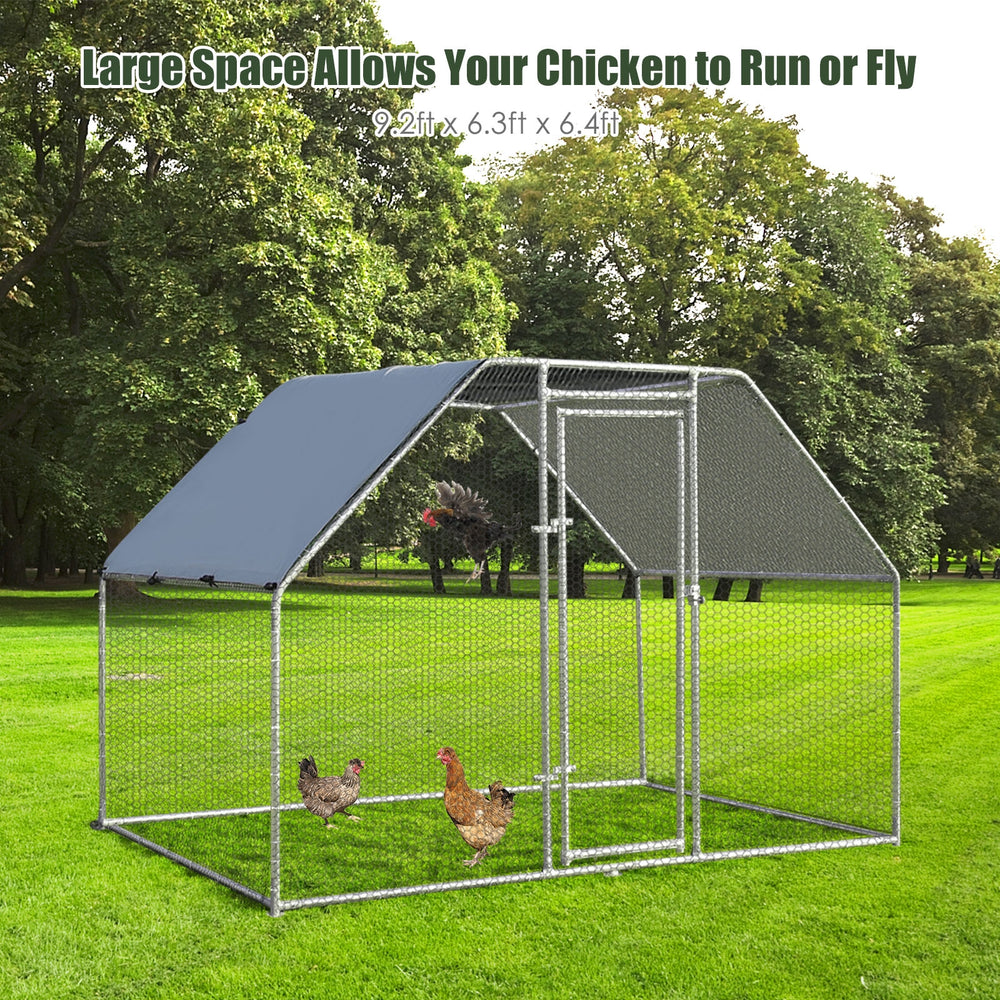Large walk-in chicken run cage with galvanized frame and waterproof cover, providing a secure outdoor space for.
