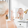 Vanity dressing table set with flip top mirror, showcasing a woman applying makeup, ideal for compact spaces.