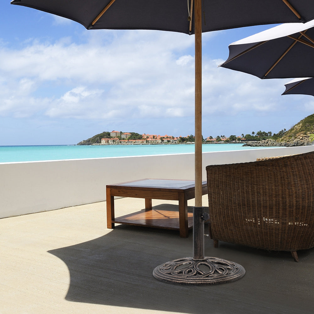 Round umbrella base stand made of premium cast iron in classic bronze, providing stability for patio umbrellas.