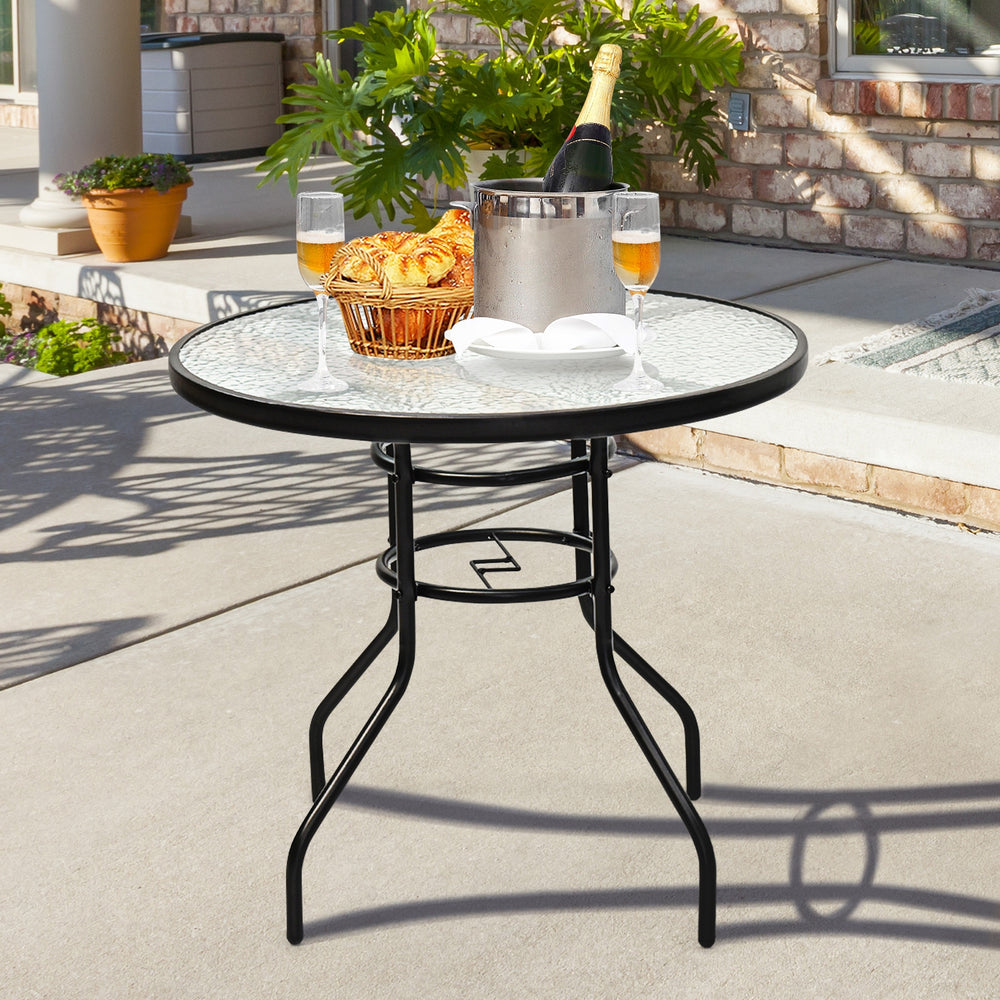 Black steel round table with a 32-inch tempered glass top, perfect for outdoor meals, featuring an umbrella hole for.