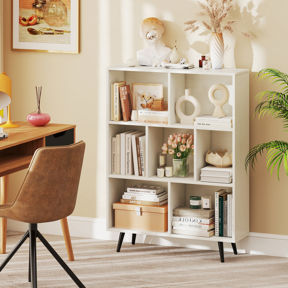 7-cube bookcase with tapered metal legs, perfect for storing books and decor in a stylish home office setup.