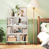 7-cube bookcase with tapered metal legs, perfect for storing books and decor in a stylish bedroom setting.