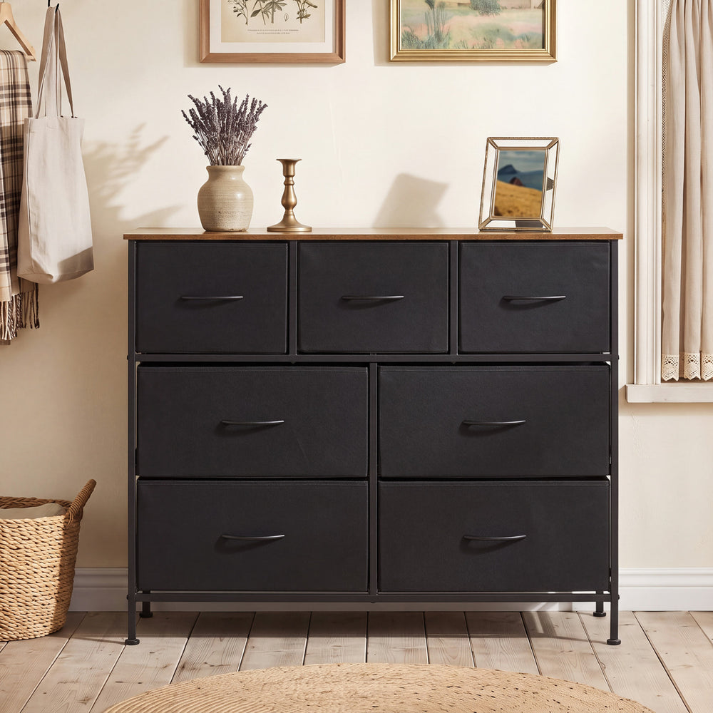 Wide black dresser featuring 7 removable fabric drawers and a spacious tabletop, ideal for bedroom storage solutions.