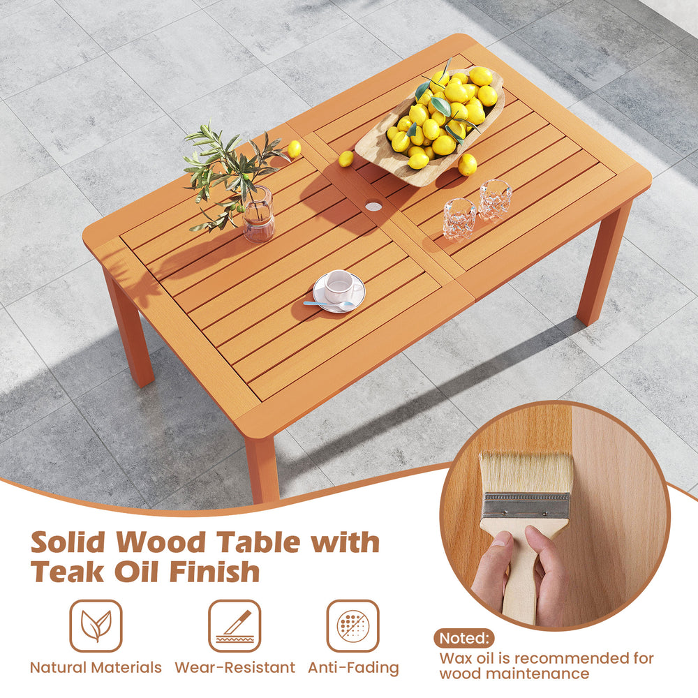 Solid wood dining table with teak oil finish, slatted design, and umbrella hole, perfect for outdoor patios and.