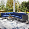 7-piece outdoor furniture set featuring navy cushions, PE rattan, and a tempered glass coffee table for backyard.