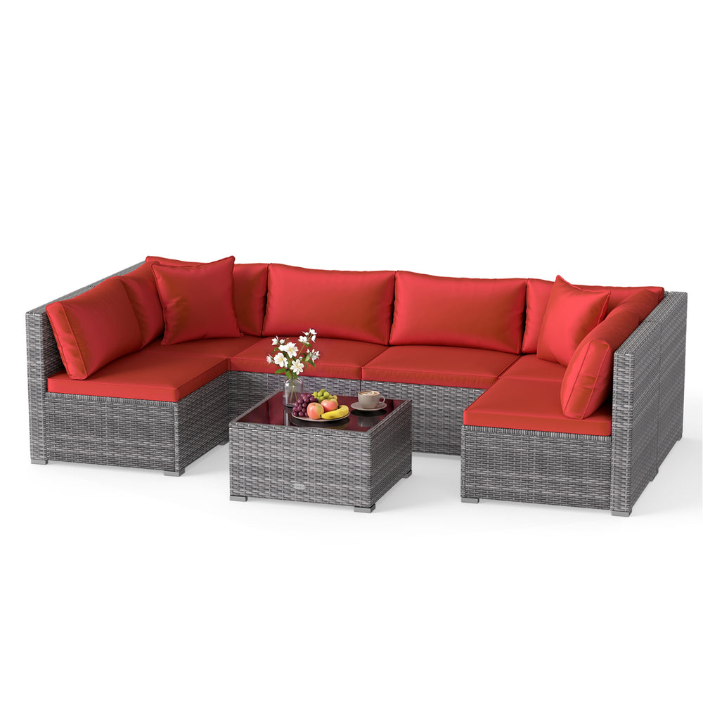 L-shaped 7-piece PE rattan patio set with red cushions and tempered glass table, ideal for outdoor relaxation.