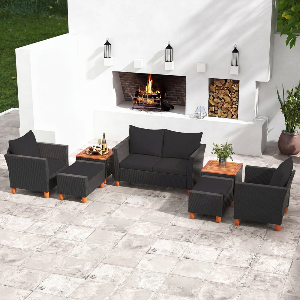 7-piece black PE rattan sectional sofa set with armchairs and acacia wood table, perfect for outdoor patio relaxation.