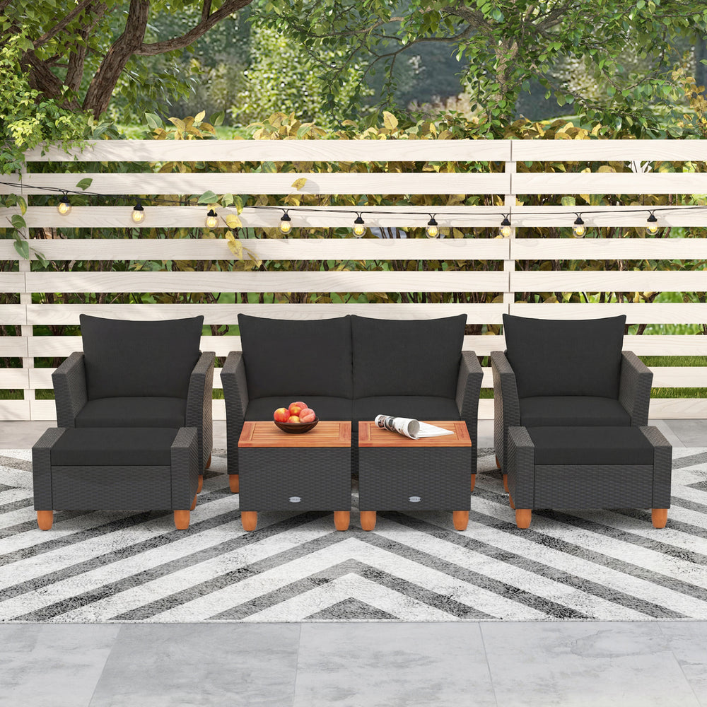 Three-piece patio furniture set featuring black PE rattan armchairs and a table with acacia wood top for outdoor.