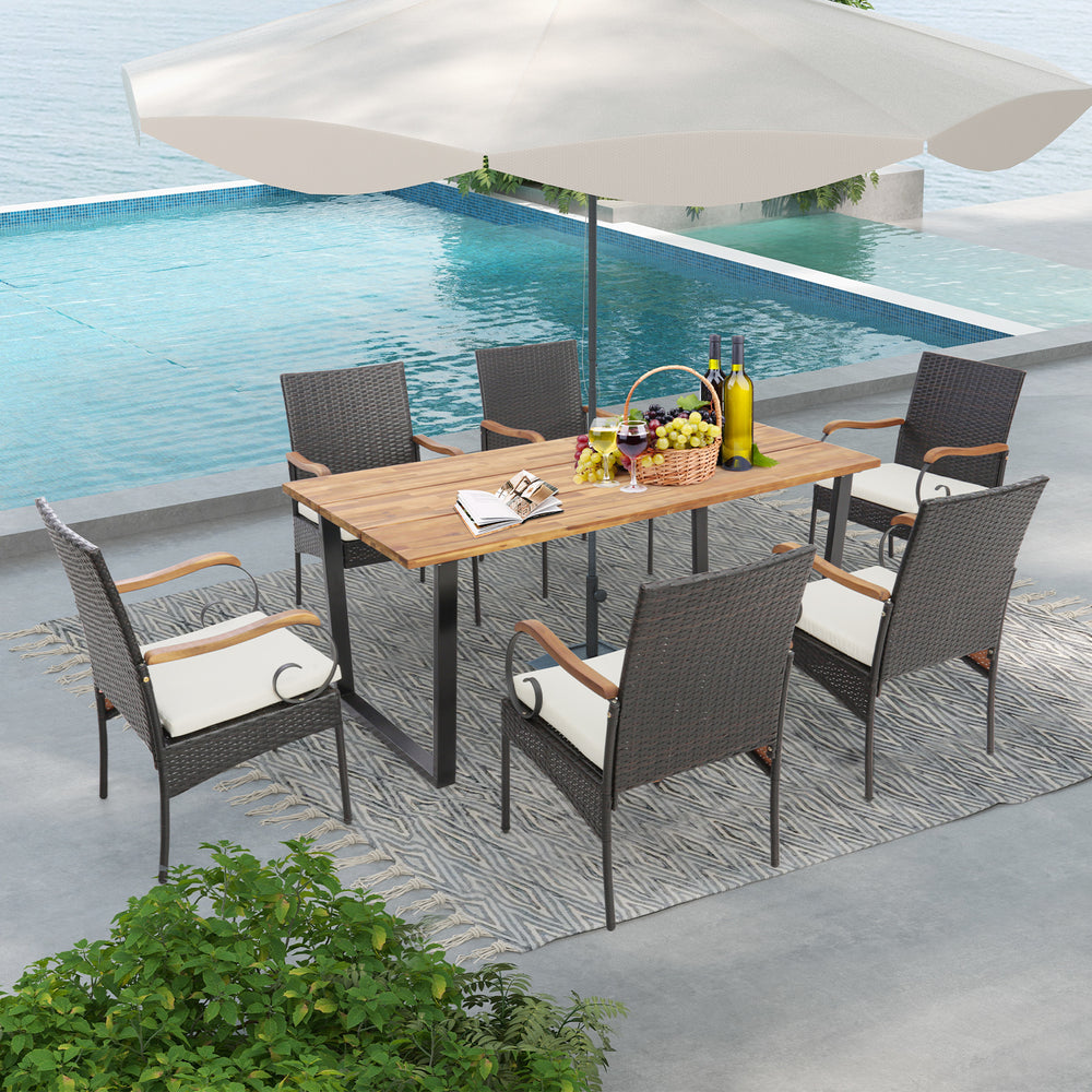 7-piece patio rattan dining set with acacia wood tabletop and ergonomic cushions, perfect for poolside gatherings.