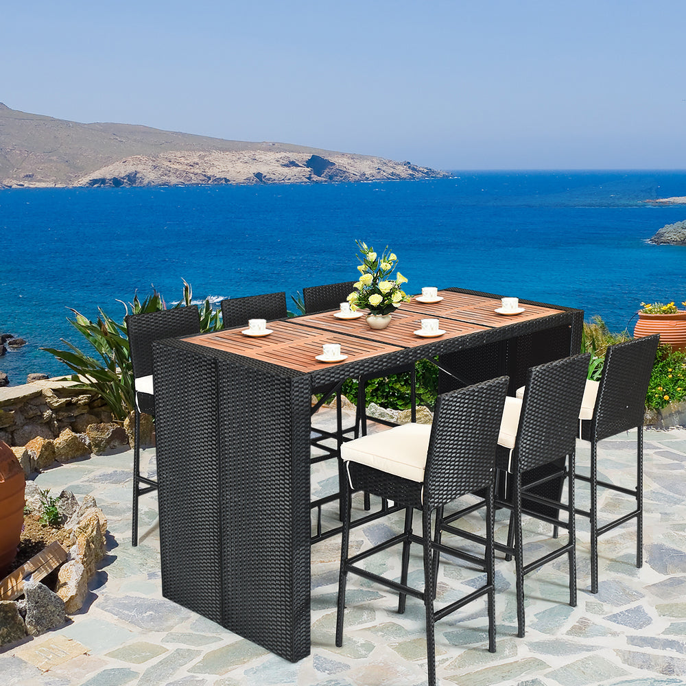 7-piece patio rattan wicker dining set with a wooden table and bar stools, perfect for outdoor dining by the sea.