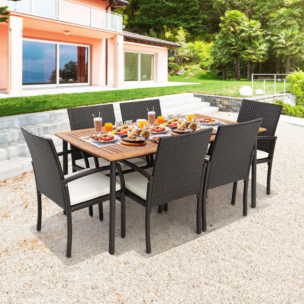 7-piece patio dining set featuring acacia wood tabletop, cushioned chairs, and umbrella hole for outdoor dining.