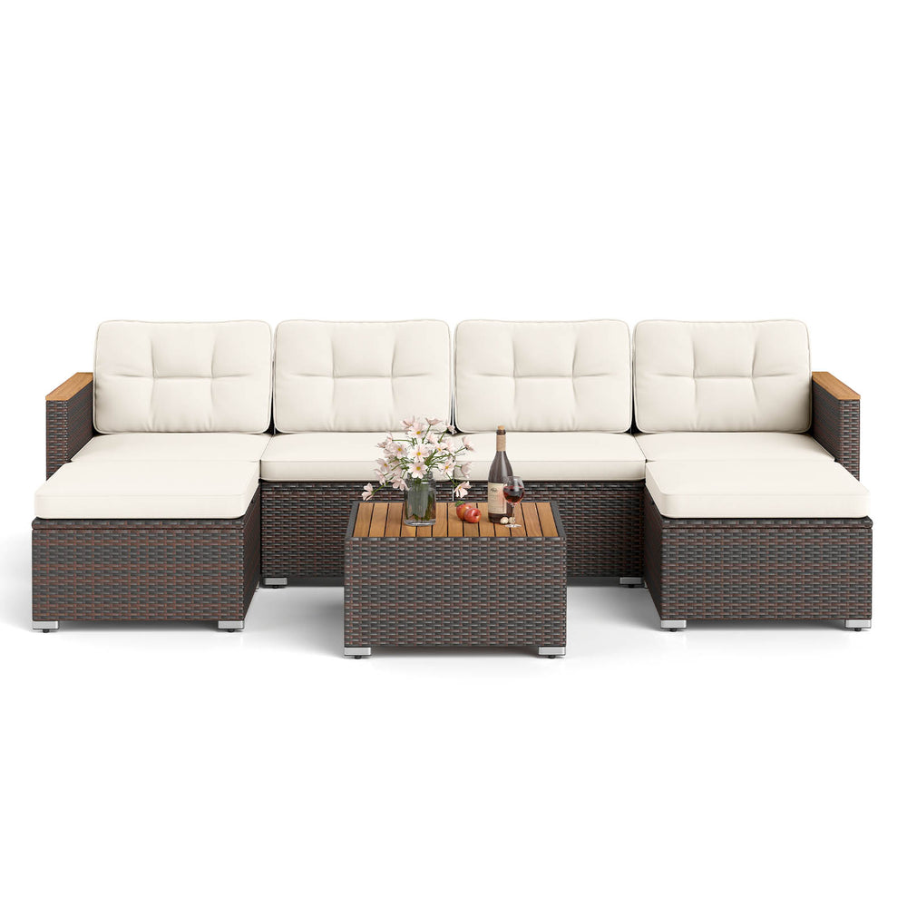 U-shaped 7-piece wicker conversation set with white cushions and acacia wood armrests, perfect for backyard relaxation.