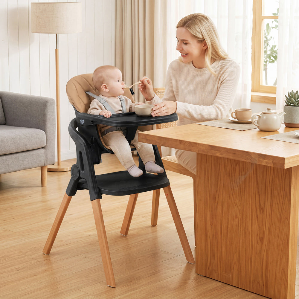 Convertible 7-in-1 baby high chair with adjustable tray, solid beech wood legs, and comfortable seat cushion for mealtime.
