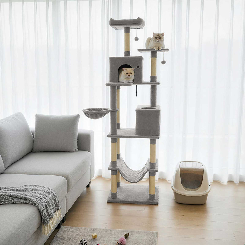 Tall light gray cat tree with two large condos, plush perches, and dangling toys for multiple cats to enjoy.