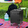 81 Quart insulated food pan carrier with wheels, shown in a picnic setting, ideal for outdoor events and food transport.