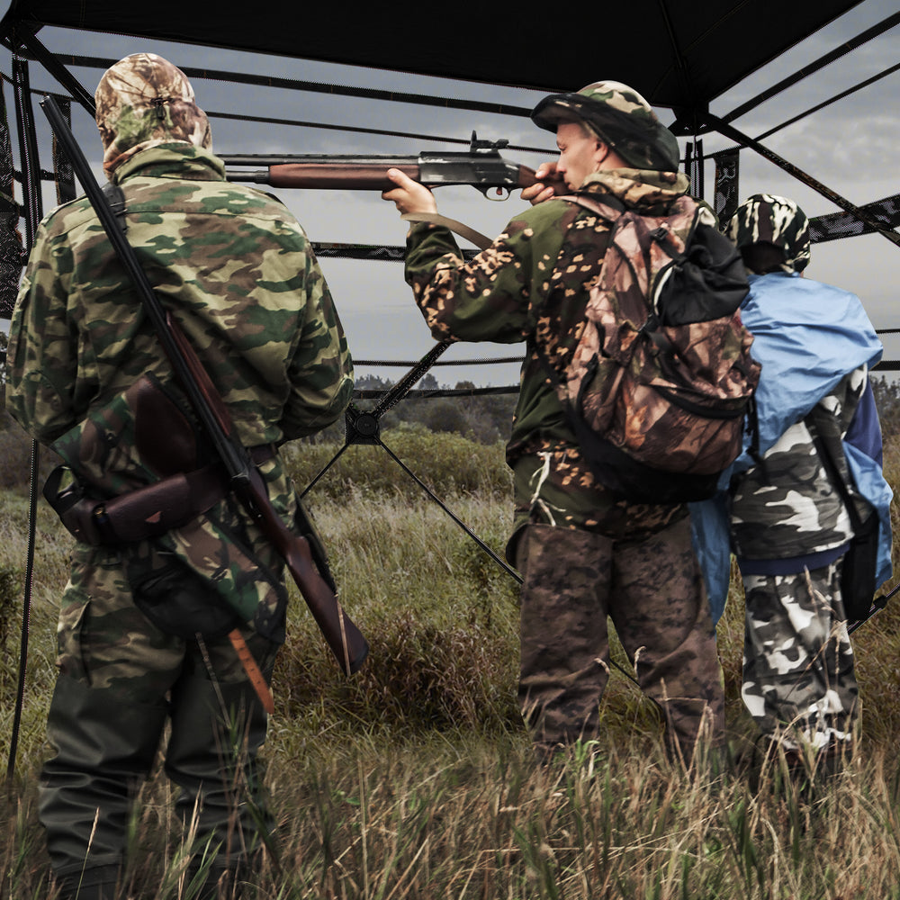Hunting blind with camouflage pattern, 82" tall, accommodates 3-4 hunters, featuring one-way see-through panels for.
