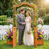 Garden arbor with gate and planter boxes, featuring a rustic finish, ideal for outdoor weddings and climbing plants.