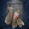 Hanging animated zombie prisoner decoration with glowing red eyes, creepy sounds, and detailed features for Halloween.