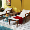 Two reclining lounge chairs with white cushions and wooden frames, perfect for outdoor relaxation by the pool.