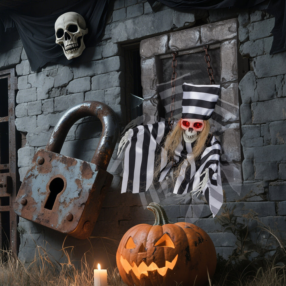 Hanging 18-inch animated skull prisoner decoration with LED eyes, chains, and creepy sound effects for Halloween.