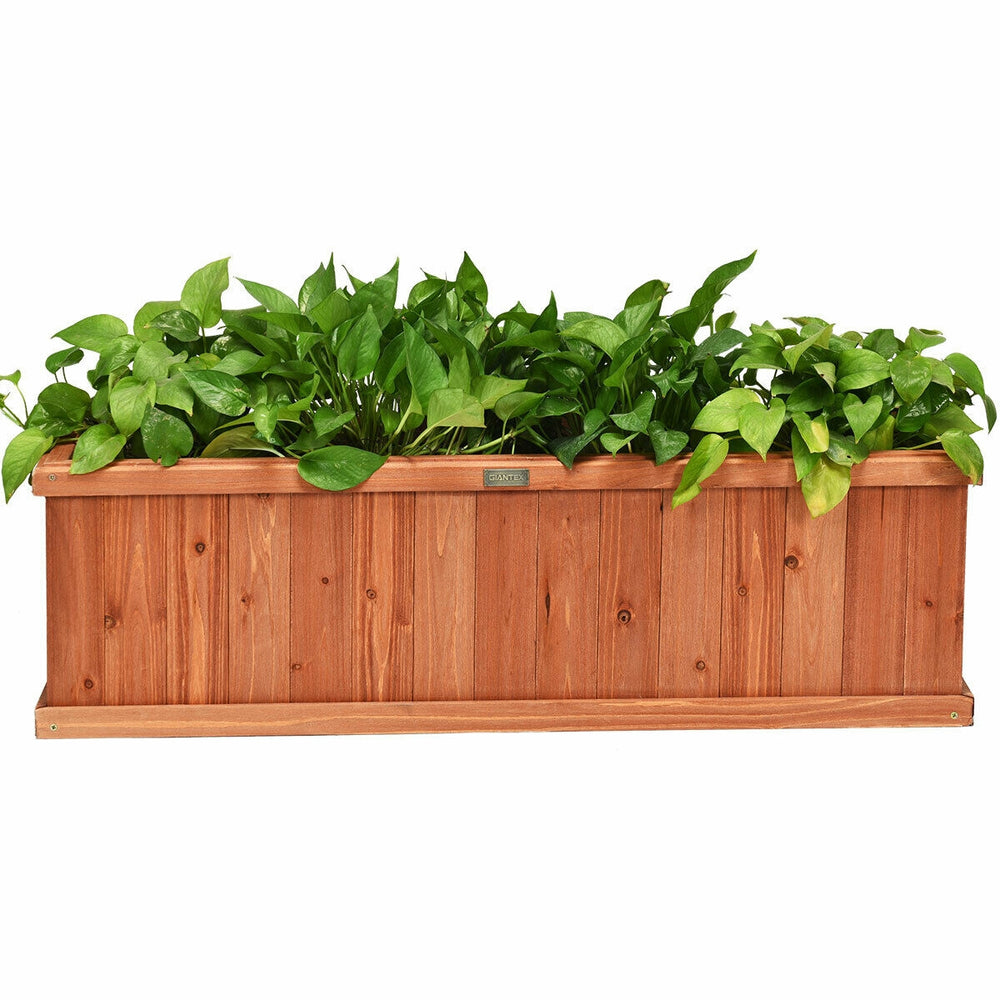 Wooden decorative planter box made from natural fir, featuring lush green plants, ideal for garden or window display.