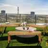 Outdoor acacia wood dining bench with a hollow slat design, providing seating for three, ideal for patios and gardens.