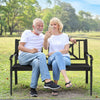 Patio garden bench with powder coated steel frame, seating two people comfortably in a park setting.