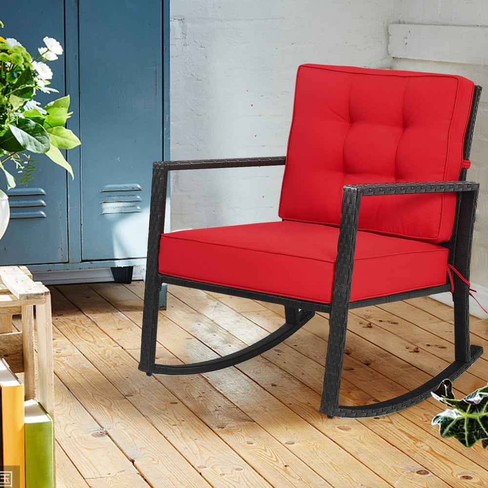 Red cushion rocking chair made of PE rattan and metal, perfect for outdoor patio or indoor living spaces.