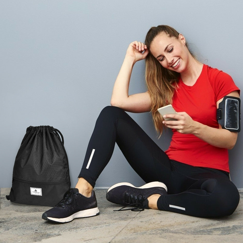 Drawstring backpack in black with zipper pockets, ideal for gym and outdoor activities, featuring upgraded shoulder.