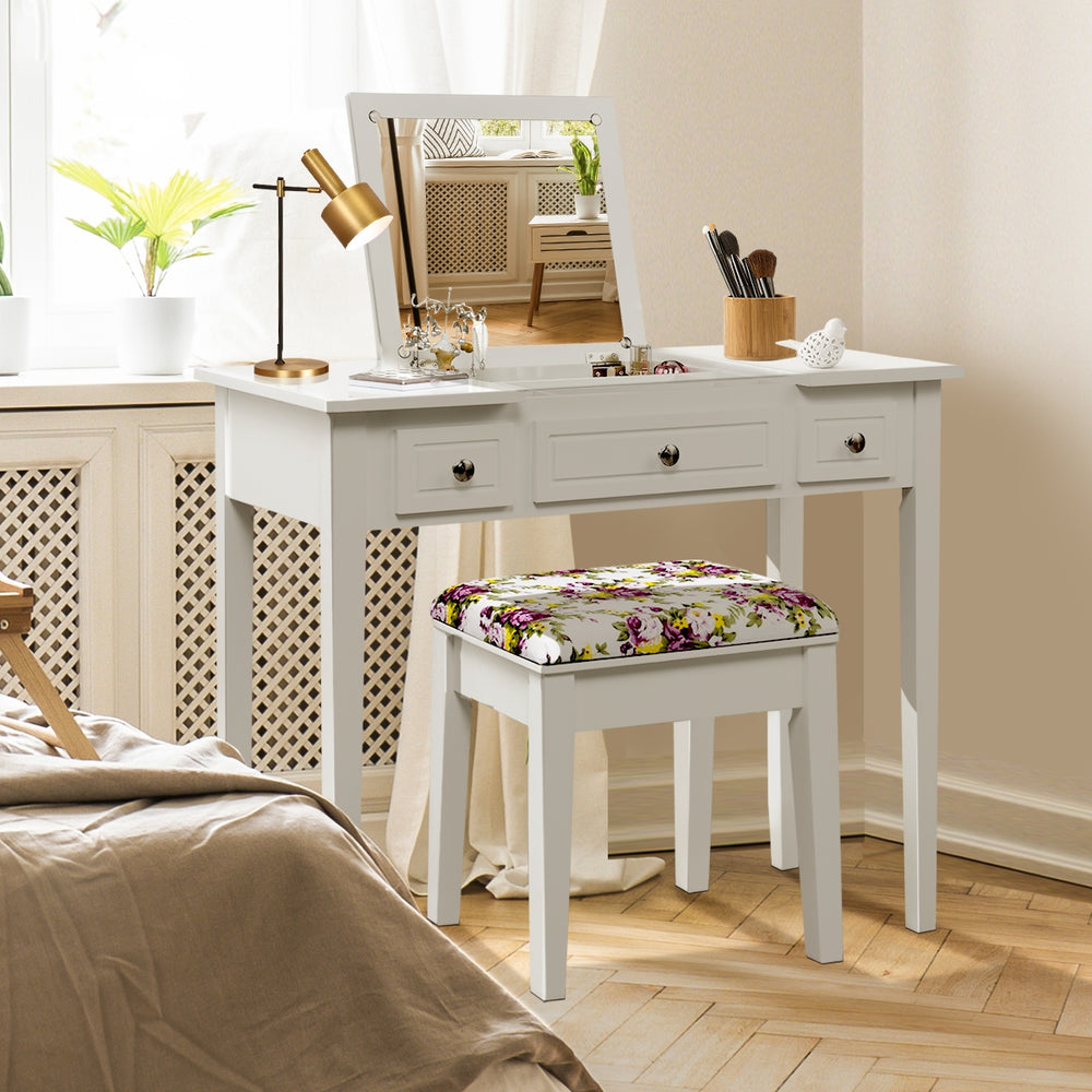 Vanity dressing table set with flip top mirror, 3 drawers, and floral stool, perfect for compact spaces and cosmetics.