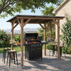 Grill gazebo with cedar wood frame, sloped metal roof, and two side serving shelves for outdoor BBQ gatherings.