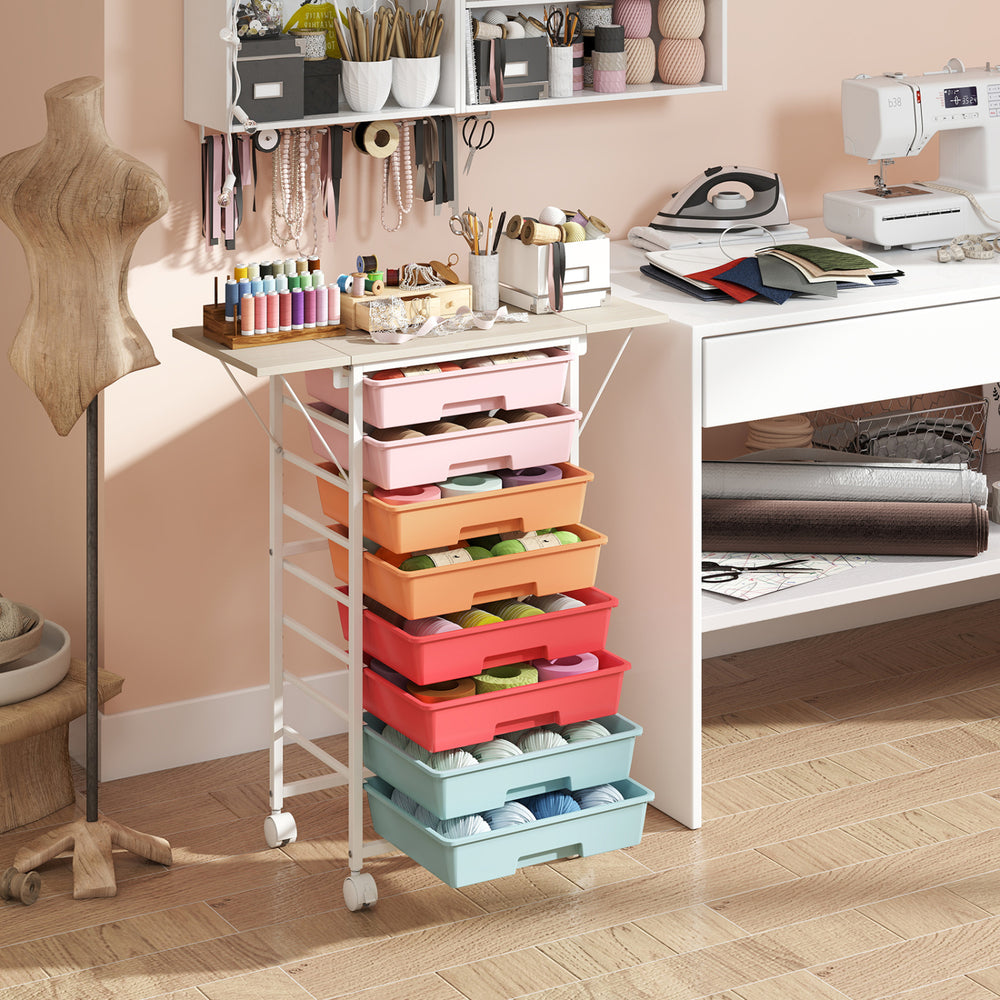 Rolling storage cart with 8 colorful drawers and a spacious tabletop, ideal for organizing craft supplies and stationery.