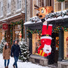 Climbing Santa Claus and reindeer inflatable roof decoration with built-in LED lights for a festive outdoor display.