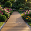 Brown outdoor pathway boardwalk surrounded by vibrant flowers and greenery, ideal for garden walkways.