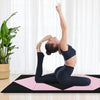 Folding gymnastics mat in black and pink, featuring a woman practicing yoga, ideal for fitness and stretching.