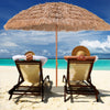 Thatched tiki umbrella providing shade on the beach, featuring durable polyester fabric and a tropical Hawaiian design.